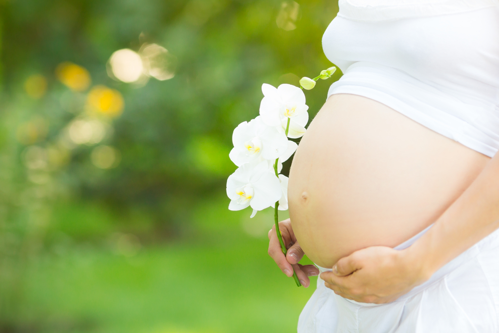 Beautiful belly of young pregnant woman